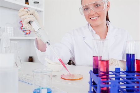 Gorgeous red-haired scientist using a pipette in a lab Stock Photo - Budget Royalty-Free & Subscription, Code: 400-04881598