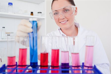 Beautiful red-haired female holding a test tube in a lab Stock Photo - Budget Royalty-Free & Subscription, Code: 400-04881591