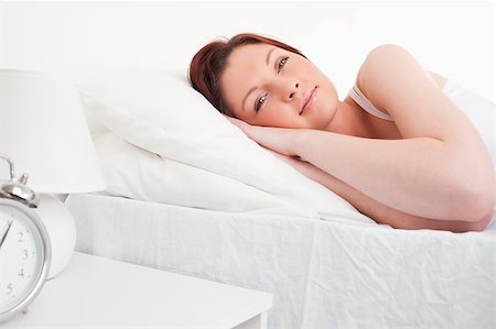 simsearch:400-04881612,k - Beautiful red-haired female having a rest while lying on her bed Stock Photo - Budget Royalty-Free & Subscription, Code: 400-04881654