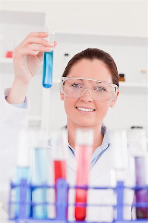 Young scientist looking at test tubes with the camera focus on the scientist Stock Photo - Budget Royalty-Free & Subscription, Code: 400-04881767