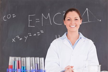 scientist and teacher photo - Cute scientist standing in front of a blackboard looking at the camera Stock Photo - Budget Royalty-Free & Subscription, Code: 400-04881786