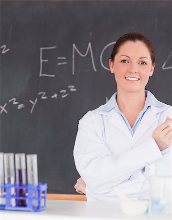scientist and teacher photo - Smilling scientist standing in front of a blackboard looking at the camera Stock Photo - Budget Royalty-Free & Subscription, Code: 400-04881789