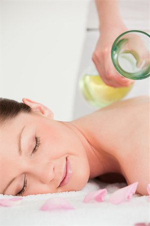 resort outdoor bed - Portrait of a young female having massage oil versed on her back Stock Photo - Budget Royalty-Free & Subscription, Code: 400-04881827