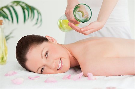 resort outdoor bed - Smiling woman getting massage oil on a her back by a masseuse Stock Photo - Budget Royalty-Free & Subscription, Code: 400-04881834