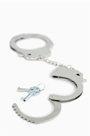 simsearch:400-04407414,k - Handcuffs and keys against a white background Fotografie stock - Microstock e Abbonamento, Codice: 400-04882233