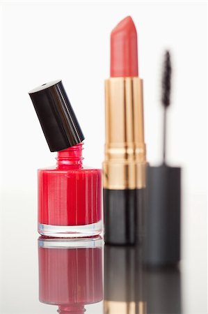 simsearch:400-05273248,k - A mascara tube with a pale red lipstick and a red nail polish flask against a white background Stock Photo - Budget Royalty-Free & Subscription, Code: 400-04882292