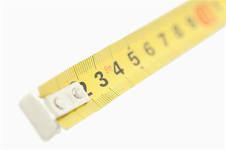 simsearch:400-07919463,k - Camera focus on a yellow measuring tape against a white background Stock Photo - Budget Royalty-Free & Subscription, Code: 400-04882300