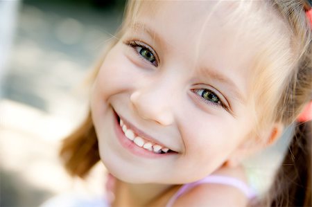 simsearch:400-05342069,k - cute little girl smiling in a park close-up Stock Photo - Budget Royalty-Free & Subscription, Code: 400-04882694