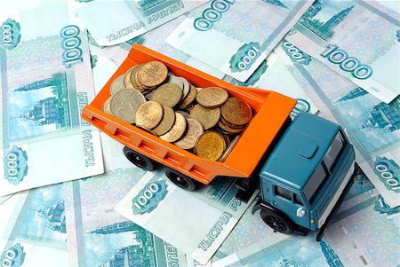 simsearch:400-08282552,k - Transportation of small coins for the toy truck. Concept. Stock Photo - Budget Royalty-Free & Subscription, Code: 400-04883145