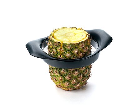 pineapple botanical - A pineapple isolated on white shown with a slicer in use Stock Photo - Budget Royalty-Free & Subscription, Code: 400-04883408