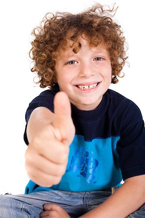 simsearch:400-06795514,k - Casual young kid showing thumbs up and smiling at camera. Photographie de stock - Aubaine LD & Abonnement, Code: 400-04883443