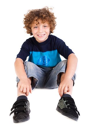 simsearch:400-06795514,k - Adorable young kid sitting on floor isolated on white.. Photographie de stock - Aubaine LD & Abonnement, Code: 400-04883455