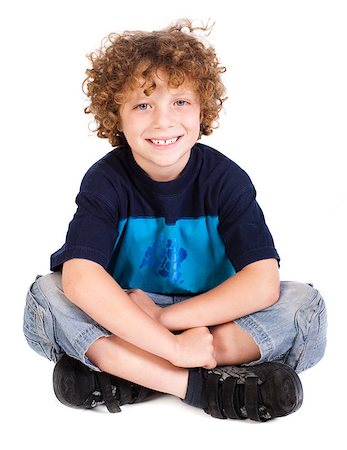 simsearch:400-06795514,k - Cheerful kid relaxing on floor isolated against on white. Photographie de stock - Aubaine LD & Abonnement, Code: 400-04883456