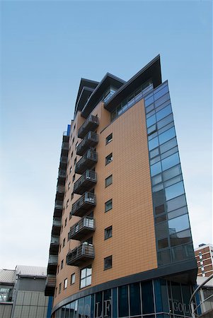 simsearch:400-04419242,k - Angular Apartment Block built of brick and glass against a ble sky Stock Photo - Budget Royalty-Free & Subscription, Code: 400-04883818