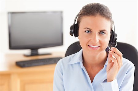 simsearch:400-04472832,k - Office worker with a headset posing in her office Stock Photo - Budget Royalty-Free & Subscription, Code: 400-04894184