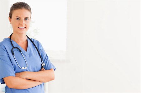 Smiling nurse posing while standing Stock Photo - Budget Royalty-Free & Subscription, Code: 400-04894192