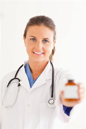 simsearch:400-05192323,k - Portrait of a charming doctor handing over some pills in the surgery Stock Photo - Budget Royalty-Free & Subscription, Code: 400-04894208