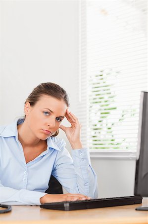 phone with pain - A businesswoman is holding her head in an office Stock Photo - Budget Royalty-Free & Subscription, Code: 400-04894222