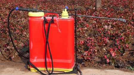 simsearch:400-07429043,k - A red sprinkler for spreading agricultural chemicals in a garden Foto de stock - Royalty-Free Super Valor e Assinatura, Número: 400-04894953