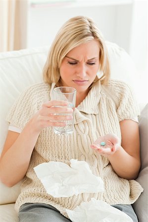 simsearch:400-07681009,k - Portrait of a tired woman taking her treatment in her living room Stockbilder - Microstock & Abonnement, Bildnummer: 400-04894978