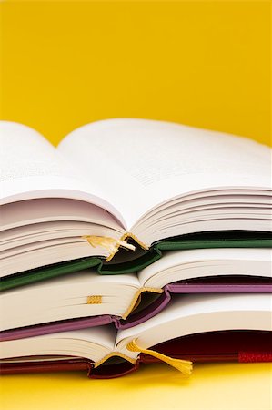 pile of open books on orange background Stock Photo - Budget Royalty-Free & Subscription, Code: 400-04894996