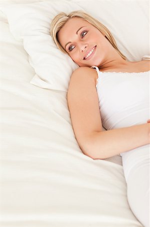 simsearch:400-05345869,k - Cute woman lying down in her bedroom Stock Photo - Budget Royalty-Free & Subscription, Code: 400-04895033