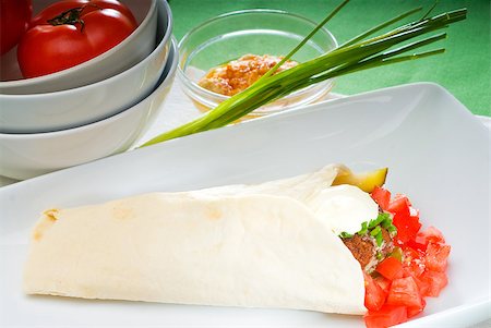 fresh traditional falafel wrap on pita bread with fresh chopped tomatoes Stock Photo - Budget Royalty-Free & Subscription, Code: 400-04895434
