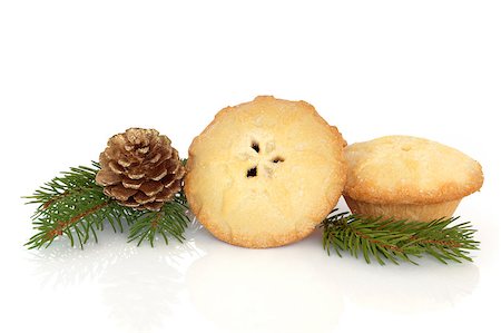 Christmas mince pies with blue fir pine leaf sprig isolated over white background. Stock Photo - Budget Royalty-Free & Subscription, Code: 400-04895672