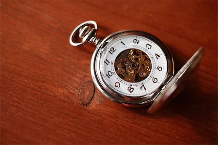 pocket watch - Pocket watch with open lid on wooden surface with copy space Stock Photo - Budget Royalty-Free & Subscription, Code: 400-04895799