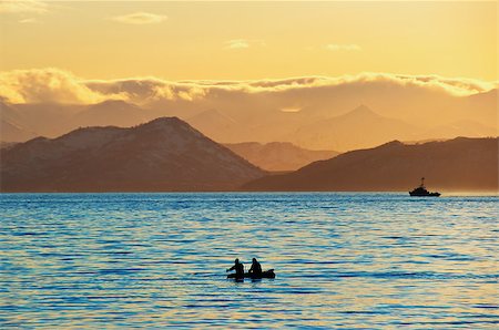 Fishermen by a boat in an evening bay Stock Photo - Budget Royalty-Free & Subscription, Code: 400-04895892