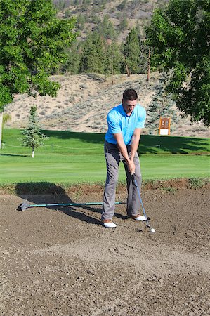 simsearch:400-04942642,k - Young male golfer hitting a shot from the bunker Photographie de stock - Aubaine LD & Abonnement, Code: 400-04896175