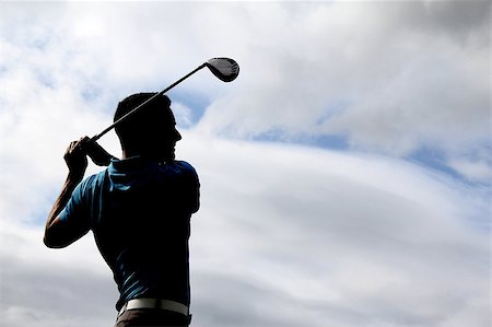 simsearch:400-05038623,k - Young golfer driving with a wood against cloudy skies Stock Photo - Budget Royalty-Free & Subscription, Code: 400-04896171