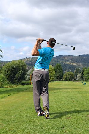 simsearch:400-05038623,k - Young golfer hitting a shot with an iron Stock Photo - Budget Royalty-Free & Subscription, Code: 400-04896173