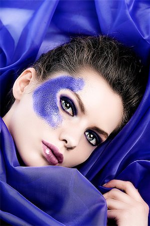 simsearch:400-04420197,k - beauty shot of a model with purple glitter make up laying between purple silk sheets Stock Photo - Budget Royalty-Free & Subscription, Code: 400-04896286