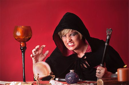 simsearch:400-05347613,k - Scary witch with sceptre and crystal ball over red background Stock Photo - Budget Royalty-Free & Subscription, Code: 400-04897181