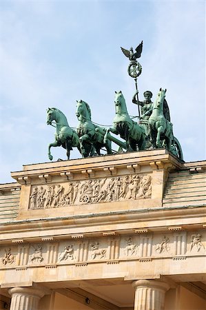 quadriga - Detail of Brandenburg Gate and the Quadriga bronze statue. In german it is called Brandenburger Tor and it's one of the few monuments that survived in the defeated capitol town of Berlin after second world war. King Frederick William II of Prussia commissioned the Gate and Carl Gotthard Langhans built it from 1788 to 1791. Stockbilder - Microstock & Abonnement, Bildnummer: 400-04897320