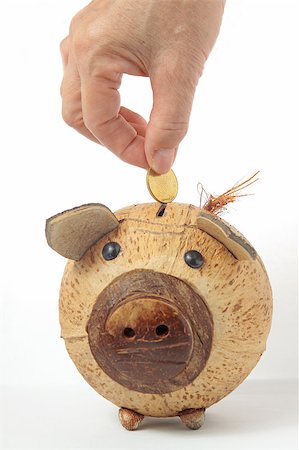 simsearch:400-04255267,k - Saving, male hand putting a coin into piggy bank. Stock Photo - Budget Royalty-Free & Subscription, Code: 400-04897384