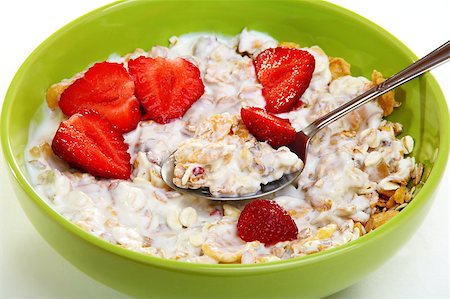 simsearch:400-06140437,k - Muesli with fruit and berries in a green cup on a white background. Stockbilder - Microstock & Abonnement, Bildnummer: 400-04897770