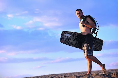 surfers men model - Portrait of a strong young  surf  man at beach on sunset in a contemplative mood with a surfboard Stock Photo - Budget Royalty-Free & Subscription, Code: 400-04898875