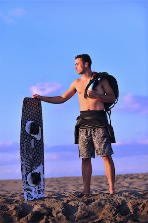 surfers men model - Portrait of a strong young  surf  man at beach on sunset in a contemplative mood with a surfboard Stock Photo - Budget Royalty-Free & Subscription, Code: 400-04898877
