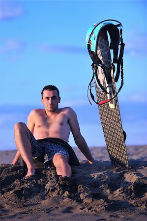 surfers men model - Portrait of a strong young  surf  man at beach on sunset in a contemplative mood with a surfboard Stock Photo - Budget Royalty-Free & Subscription, Code: 400-04898878