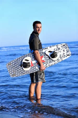 surfers men model - Portrait of a strong young  surf  man at beach on sunset in a contemplative mood with a surfboard Stock Photo - Budget Royalty-Free & Subscription, Code: 400-04898870