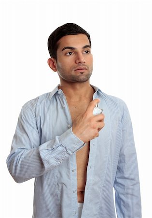 A man in the process of getting ready and dressed, sprays some cologne on skin. Photographie de stock - Aubaine LD & Abonnement, Code: 400-04899024