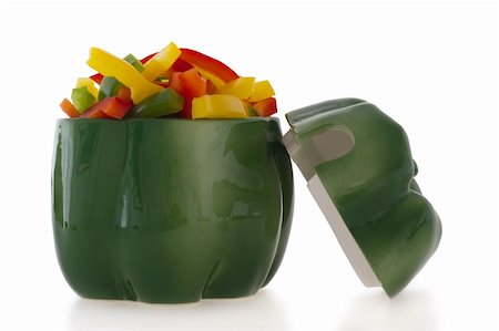 simsearch:400-06061963,k - Ceramic green pepper shaped ornament filled with cut colofrul bell pepper slices. Foto de stock - Royalty-Free Super Valor e Assinatura, Número: 400-04899029