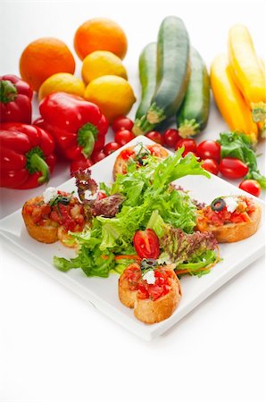 finger buffet - original Italian fresh bruschetta,typical finger food, with fresh salad and vegetables on background,MORE DELICIOUS FOOD ON PORTFOLIO Stock Photo - Budget Royalty-Free & Subscription, Code: 400-04899278