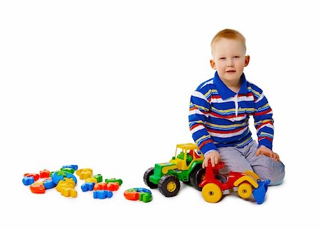 simsearch:400-05292821,k - A little boy sits on a white background with toys Stock Photo - Budget Royalty-Free & Subscription, Code: 400-04899607