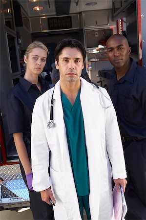 Portrait of doctor with two paramedics in front of ambulance Stock Photo - Budget Royalty-Free & Subscription, Code: 400-04890168