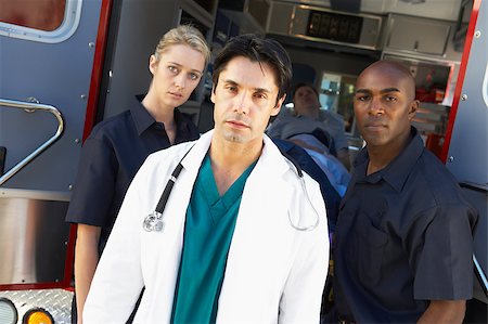 Doctor and paramedics standing in front of an ambulance Stock Photo - Budget Royalty-Free & Subscription, Code: 400-04890169