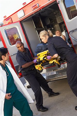 Paramedics and doctor unloading patient from ambulance Stock Photo - Budget Royalty-Free & Subscription, Code: 400-04890175