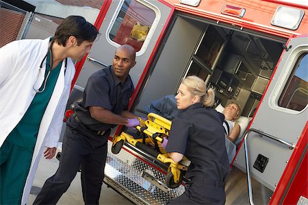 Paramedics and doctor unloading patient from ambulance Stock Photo - Budget Royalty-Free & Subscription, Code: 400-04890176